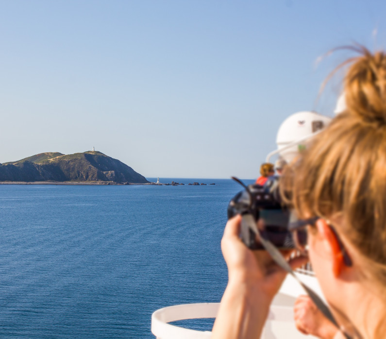 Lady photographing Pencarrow Lighthouses Wellington ScaleWidthWzc5NV0