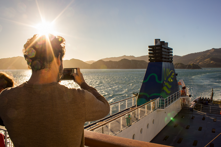 Interislander Aratere Man taking photo of West Head as ship leaves South Island RH1521
