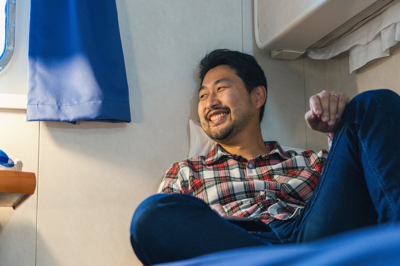 Man relaxes in Kaitaki cabin