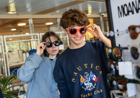 185098 gift shop teenagers try on sunglasses